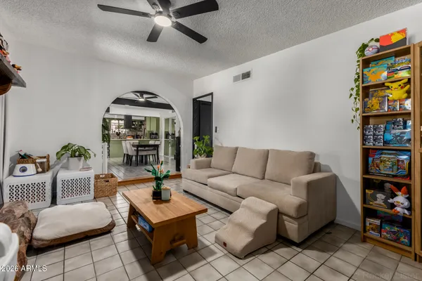 a living room with furniture a bookshelf and a book shelf