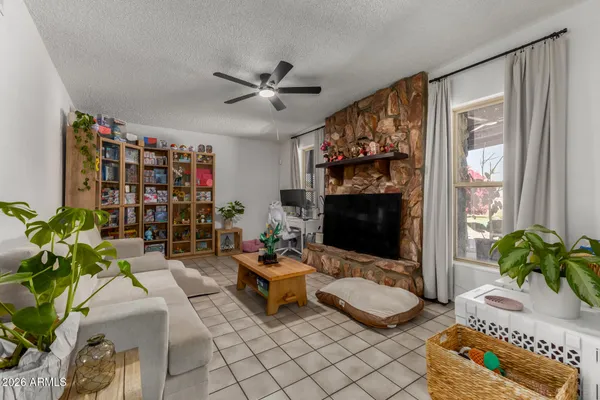 a living room with fireplace furniture and a flat screen tv