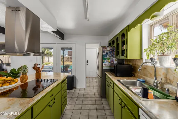 a kitchen with a sink stove and cabinets
