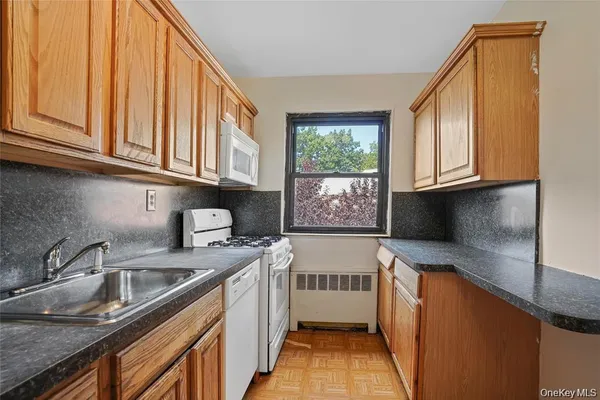a kitchen with stainless steel appliances granite countertop a sink a stove and a microwave