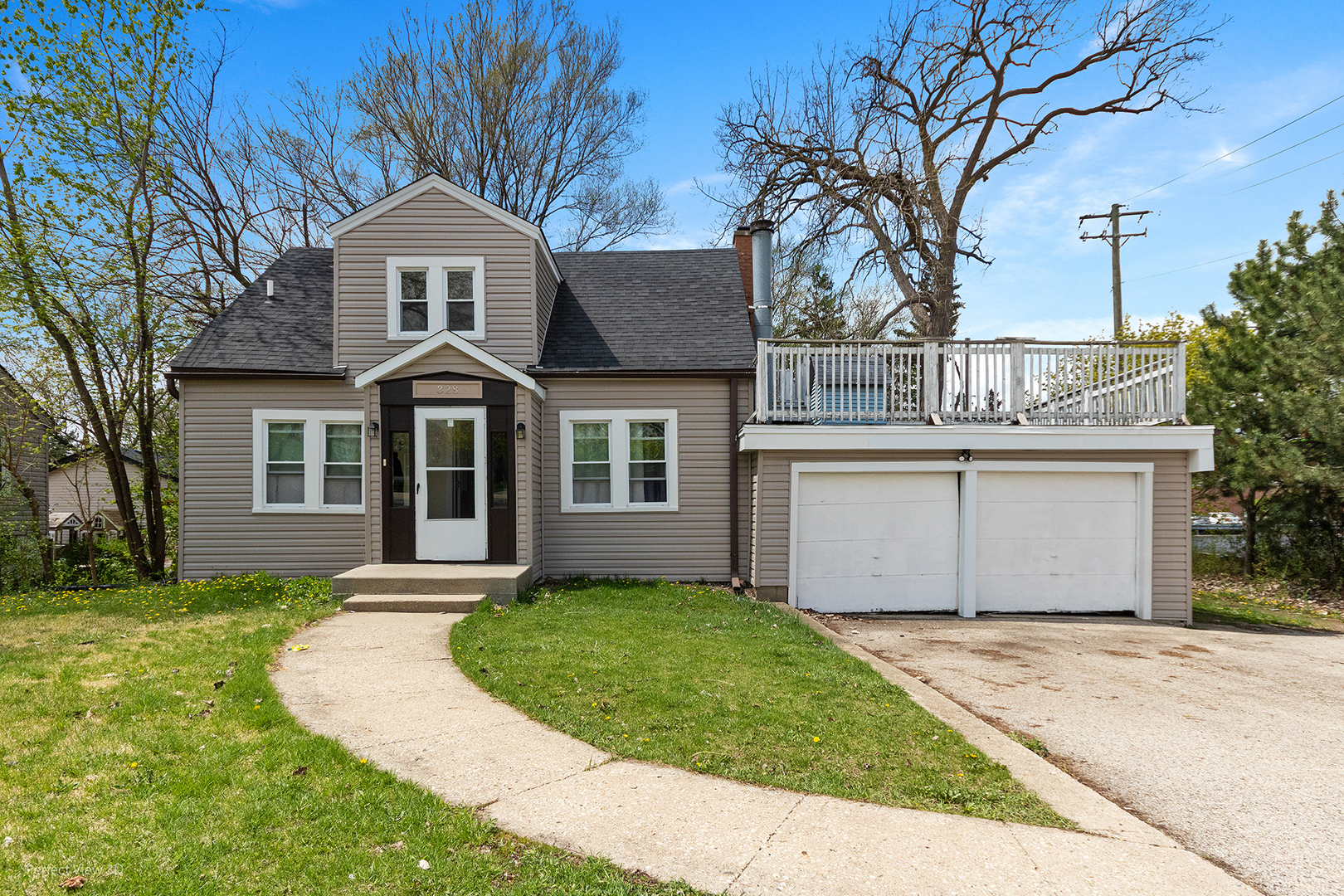 a front view of a house with a garden and yard