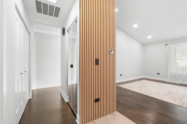 a view of a hallway with wooden floor