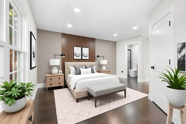 a spacious bedroom with a large bed and a potted plant