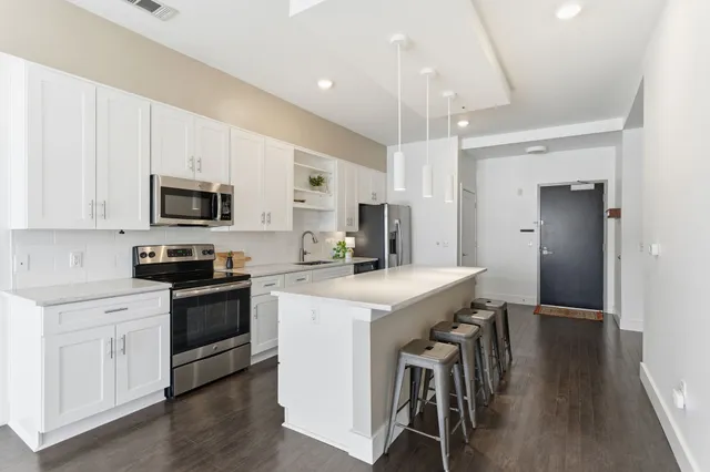 a kitchen with a stove a sink and a refrigerator