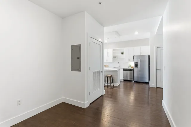 a view of a kitchen with refrigerator stove and wooden floor