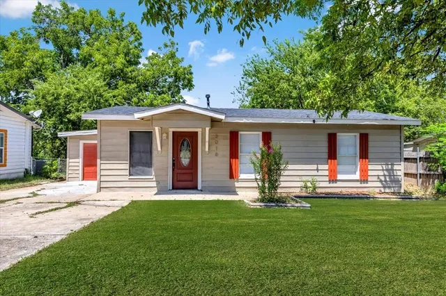 a front view of house with a garden and patio