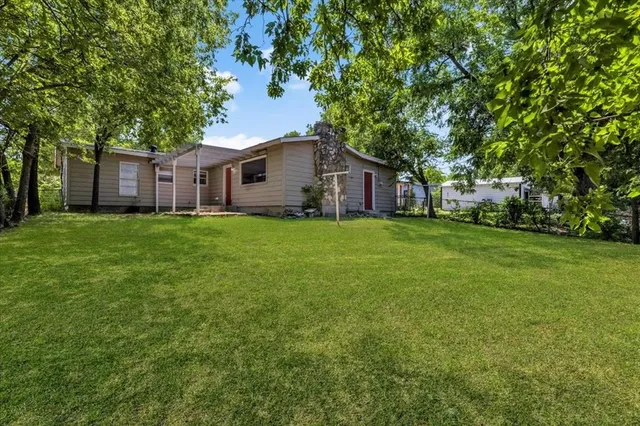 a big house with a big yard and large trees