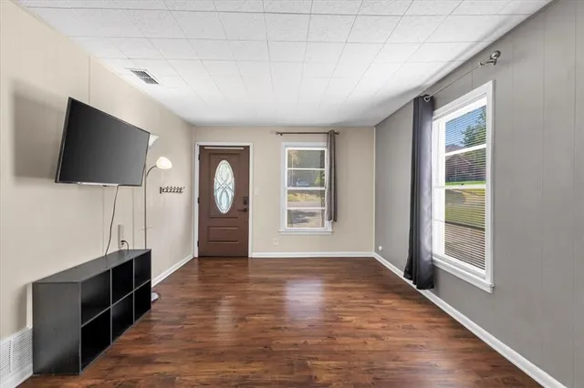 a view of a livingroom with wooden floor and a window