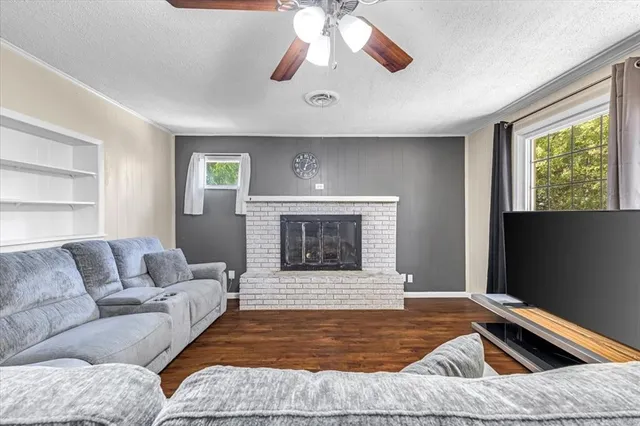 a living room with furniture and a fireplace