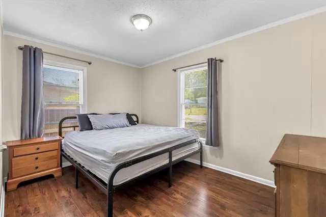 a bed sitting in a bedroom next to a window