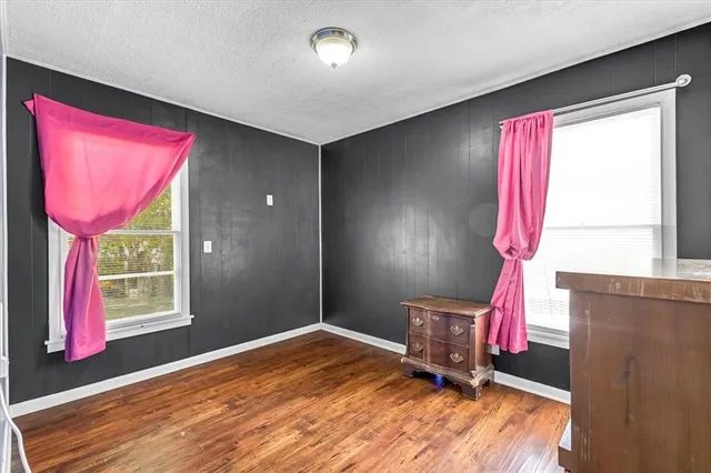a workspace with furniture window and wooden floor