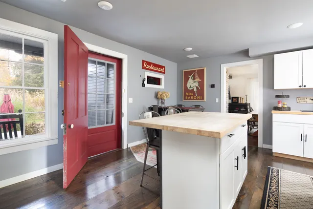 a spacious kitchen with stainless steel appliances a sink and a large window
