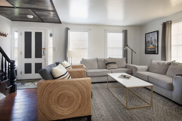 a living room with furniture and a fireplace