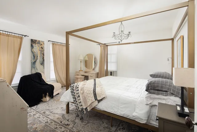 a bedroom with a bed next to a window with the outer view