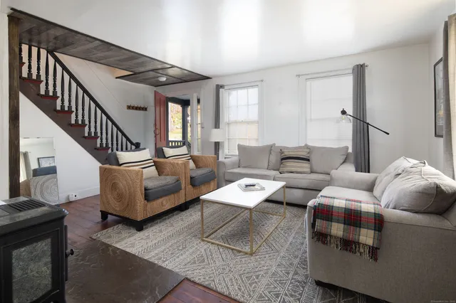 a living room with furniture and a dining table