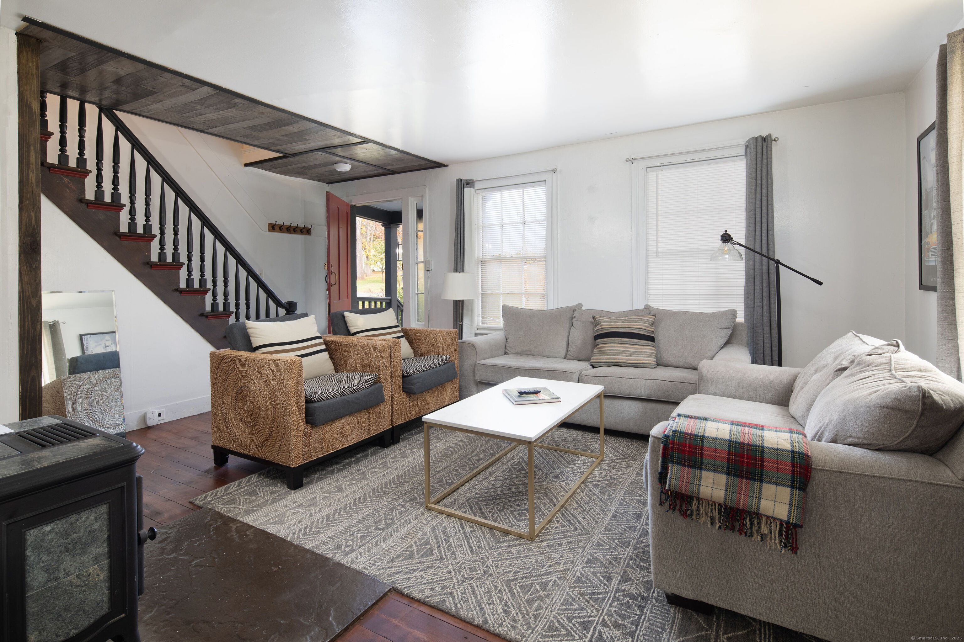 471 Lime Rock Road Salisbury, CT 06039 - Photo 3 of 24 a living room with furniture and a dining table