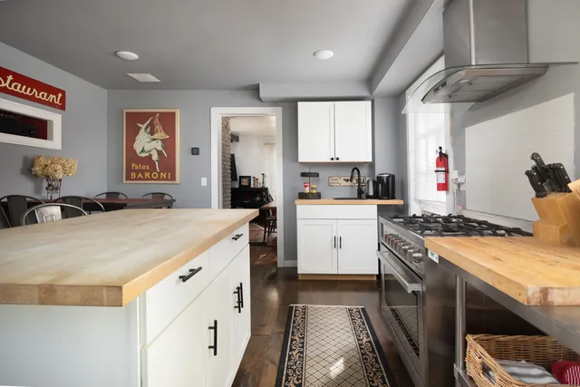 a kitchen with a stove a sink a refrigerator and cabinets