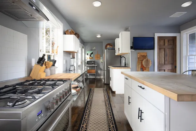 a kitchen with stainless steel appliances granite countertop a stove and a sink