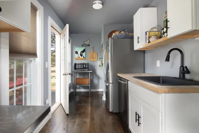a kitchen with stainless steel appliances granite countertop a refrigerator and a sink