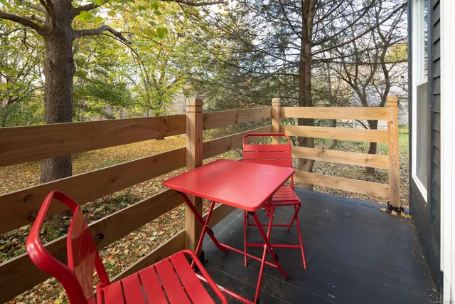 a view of a balcony with table and chairs