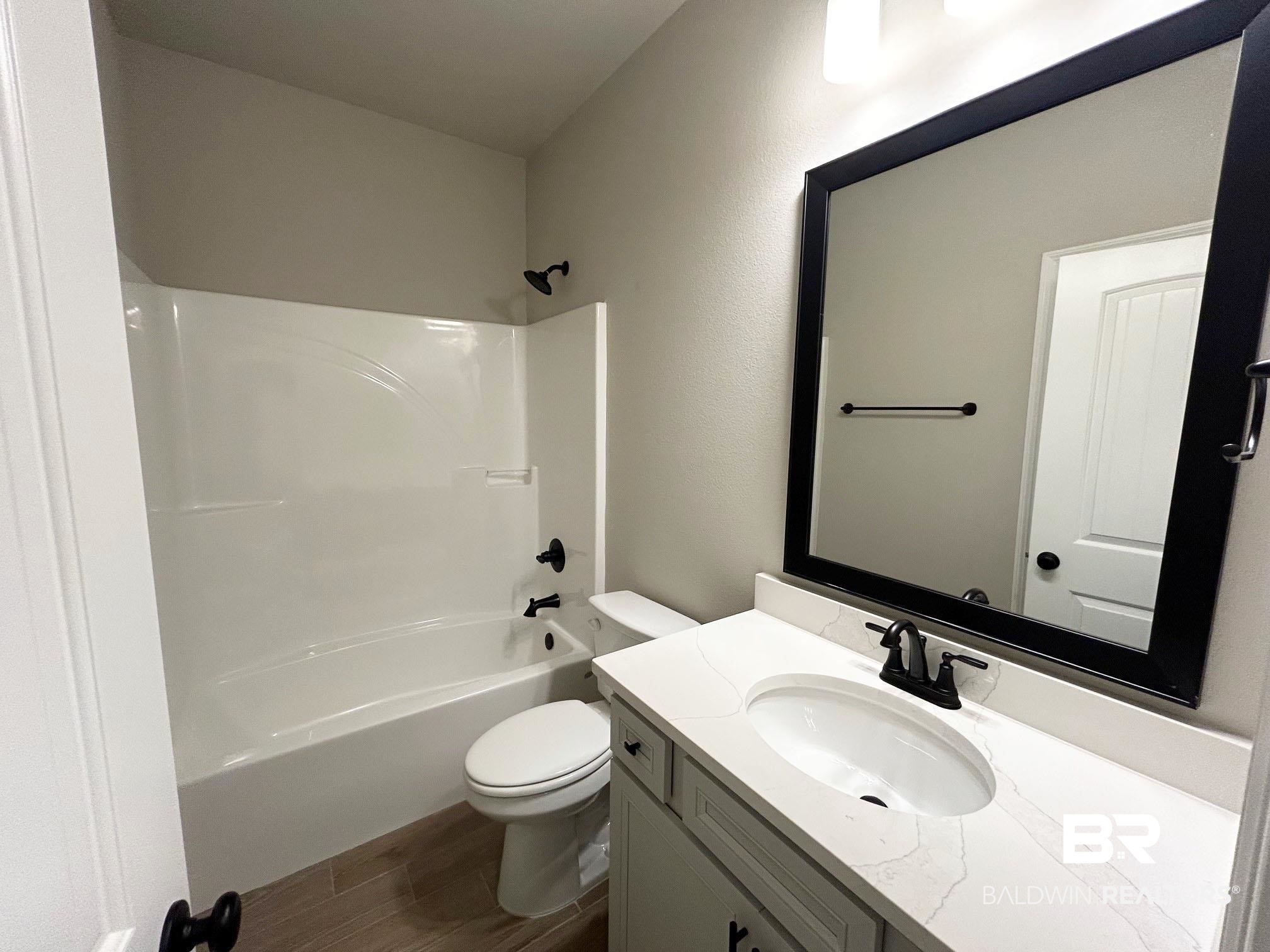 813 Sumter Loop Foley, AL 36535 - Photo 14 of 18 Full bathroom featuring shower / tub combination, vanity, and toilet