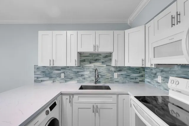 a kitchen with a sink cabinets and stainless steel appliances
