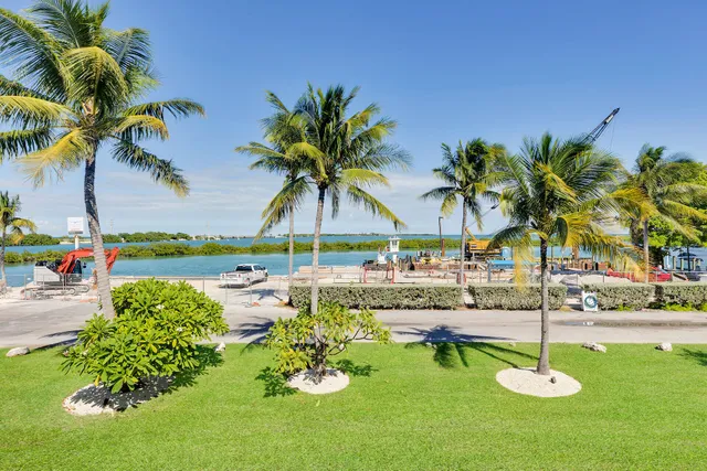 a swimming pool with outdoor seating and a garden