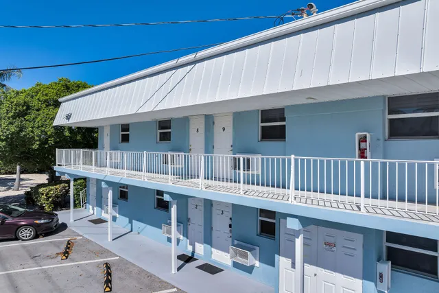 a room with furniture pool table and chairs
