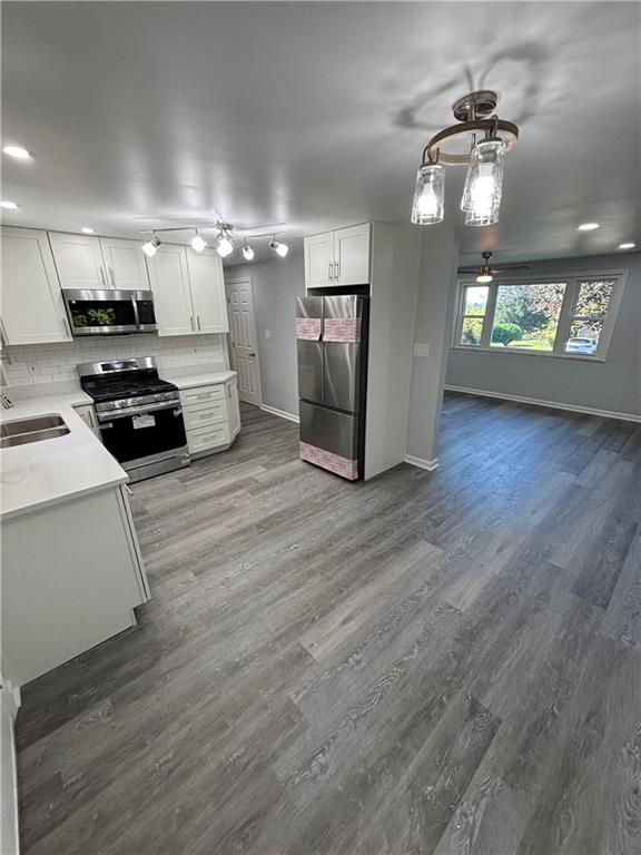 408 Highview Street Latrobe, PA 15650 - Photo 19 of 50 a kitchen with granite countertop a stove and a refrigerator