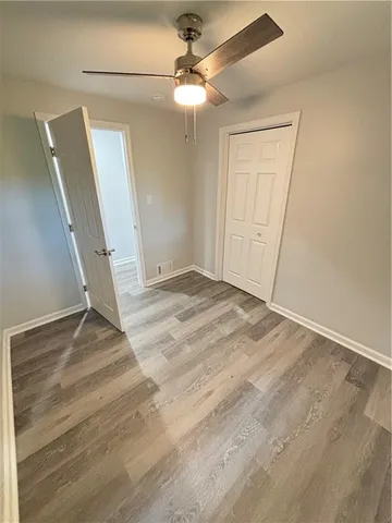a view of an empty room with a chandelier fan
