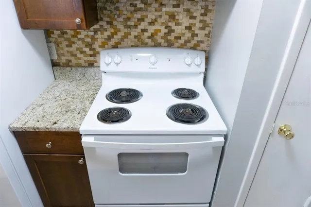 a kitchen with a stove and a refrigerator