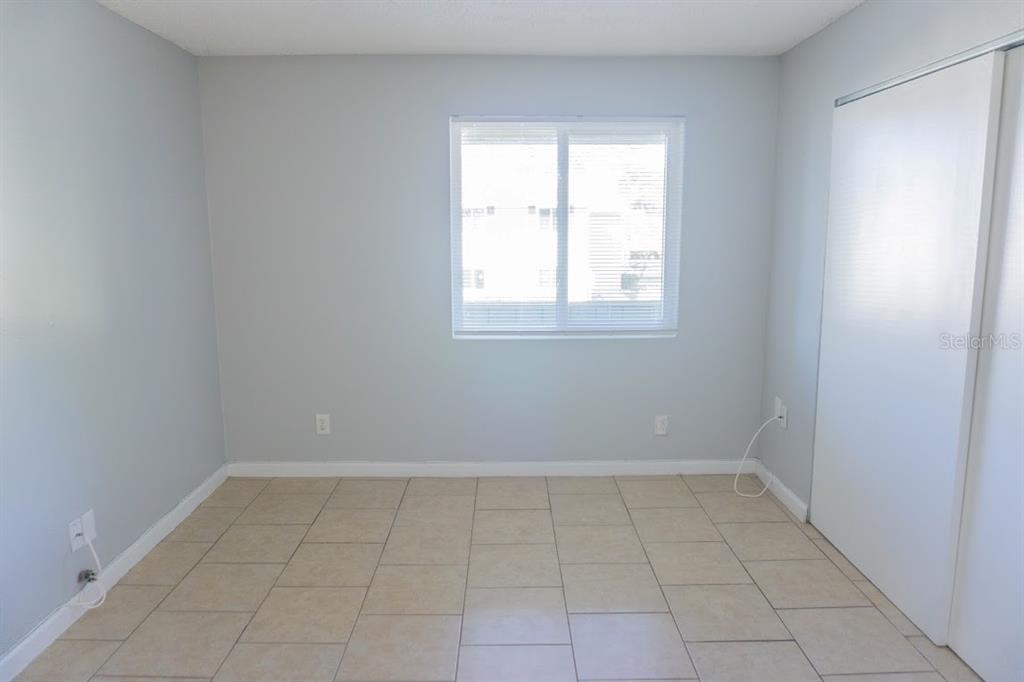 237 Thorntree Place, Unit 237 Brandon, FL 33510 - Photo 15 of 55 an empty room with white walls and tiles