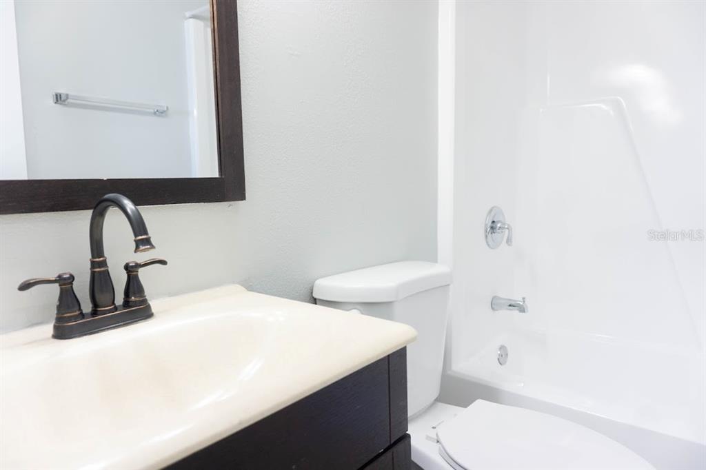 237 Thorntree Place, Unit 237 Brandon, FL 33510 - Photo 23 of 58 a bathroom with a sink a toilet and mirror
