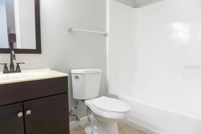 a bathroom with a sink toilet and mirror