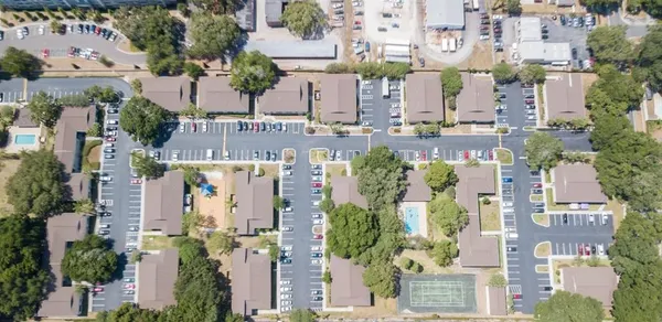 an aerial view of residential houses with outdoor space