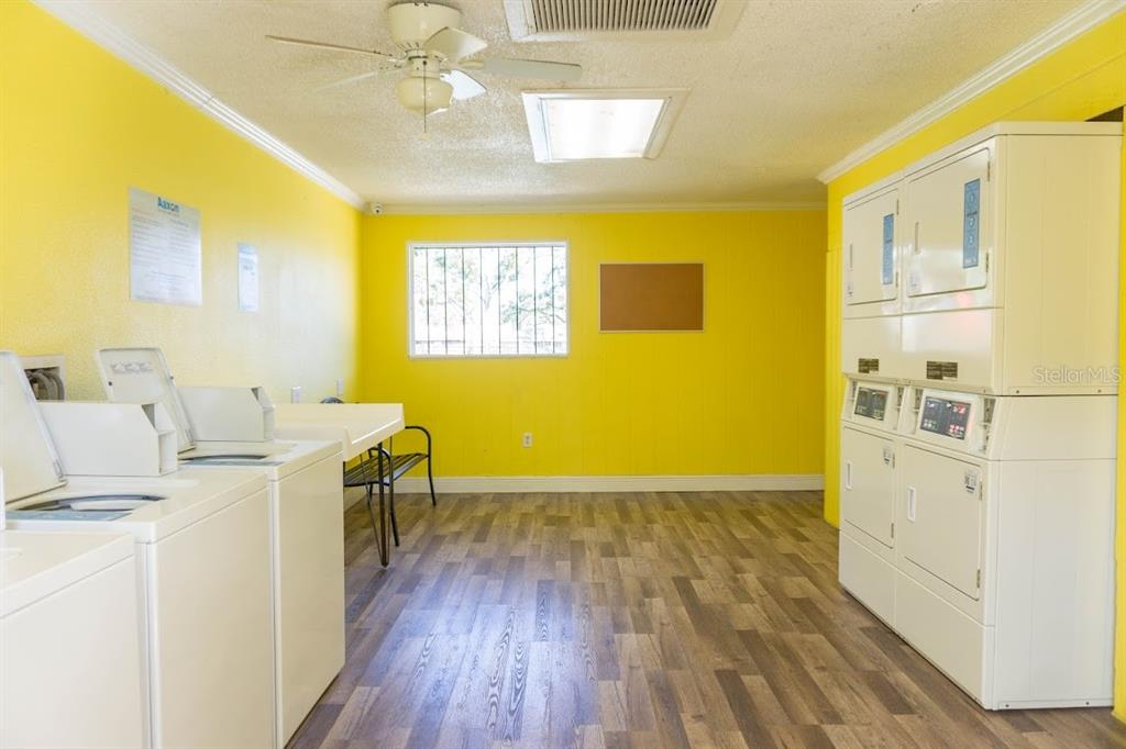 237 Thorntree Place, Unit 237 Brandon, FL 33510 - Photo 55 of 58 a view of a kitchen with wooden floor and a refrigerator