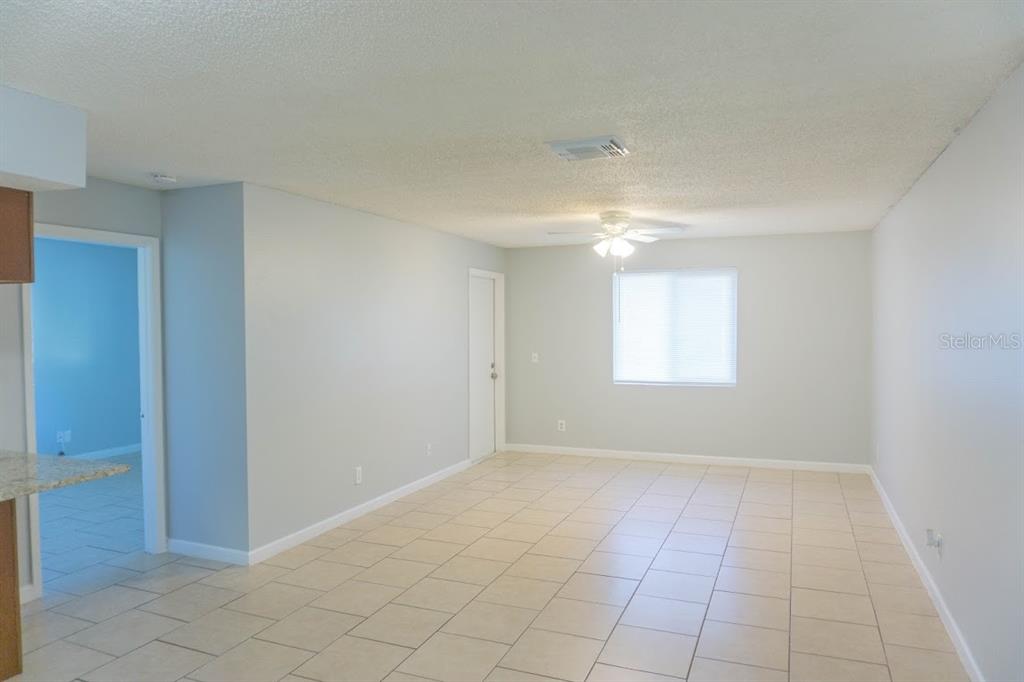 237 Thorntree Place, Unit 237 Brandon, FL 33510 - Photo 7 of 58 a view of an empty room with window and chandelier fan