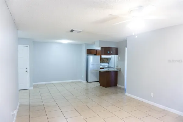 a view of kitchen with refrigerator and window