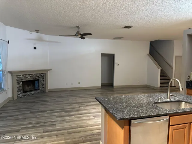 a kitchen with kitchen island a counter top a sink and a stove