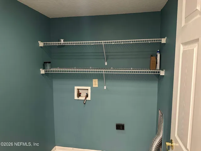 a view of a room with a window and a ceiling fan