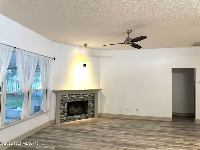 a view of a livingroom with a fireplace and window
