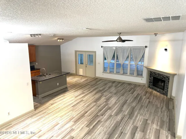 a spacious bathroom with a sink and a mirror