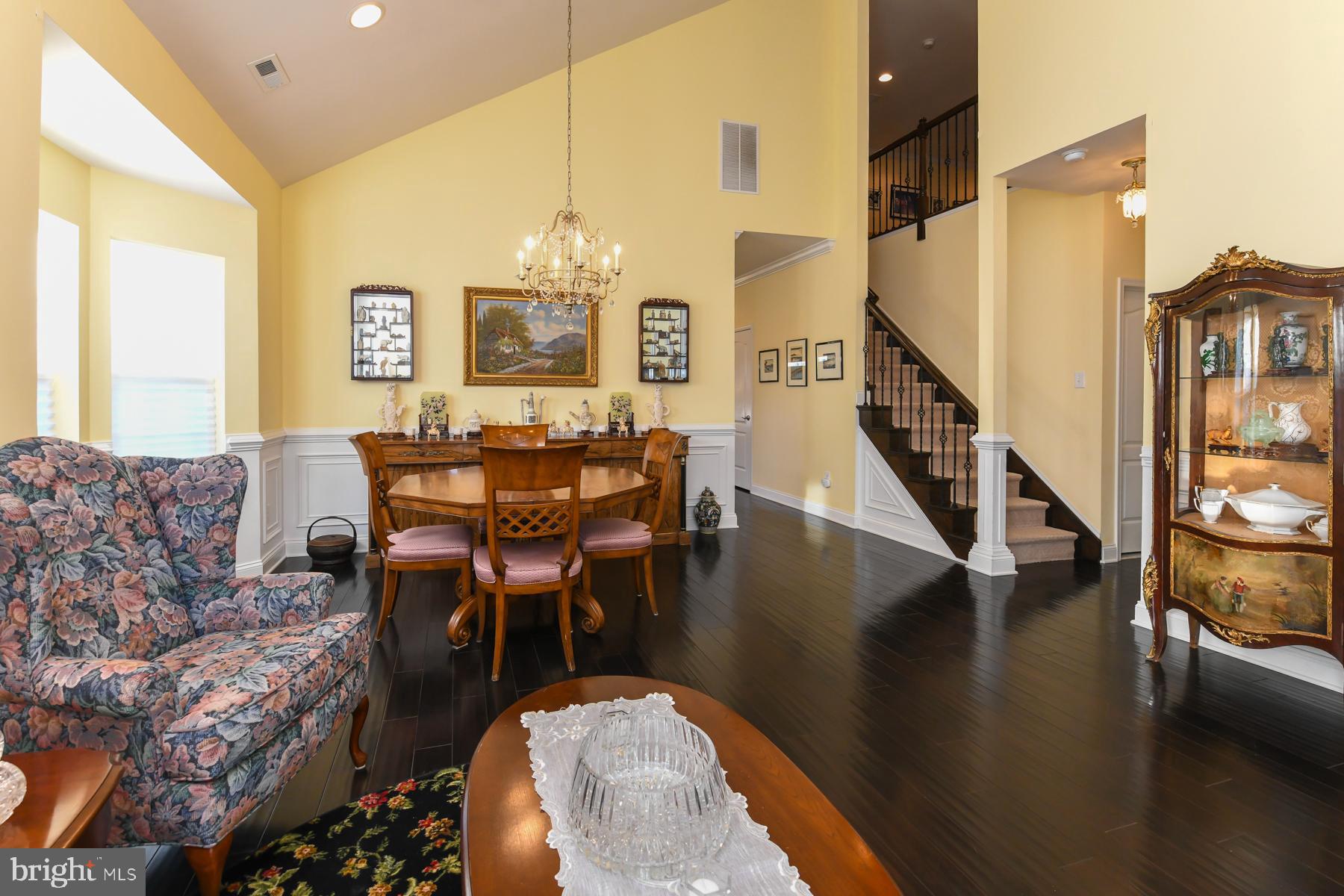 111 Weatherby Lane Glassboro, NJ 08028 - Photo 11 of 95 a living room with couches chairs and a dining table with wooden floor