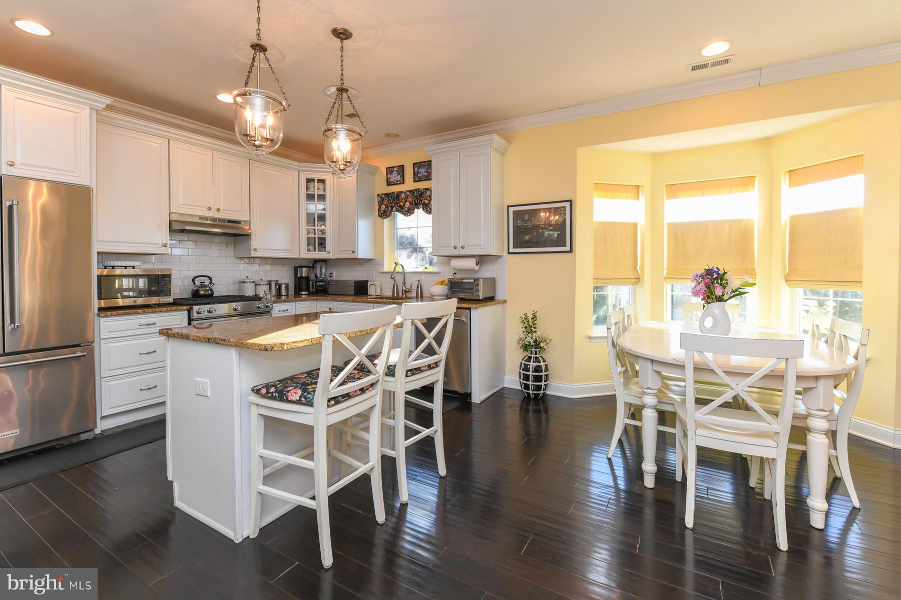 111 Weatherby Lane Glassboro, NJ 08028 - Photo 20 of 95 a kitchen with stainless steel appliances granite countertop a table chairs refrigerator and microwave