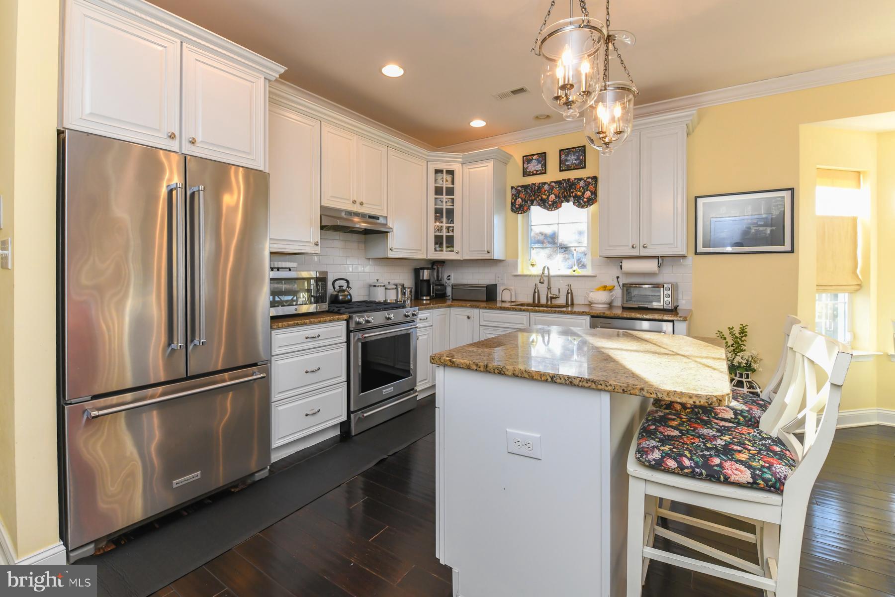 111 Weatherby Lane Glassboro, NJ 08028 - Photo 25 of 95 a kitchen with granite countertop a refrigerator oven a sink dishwasher and white cabinets with wooden floor