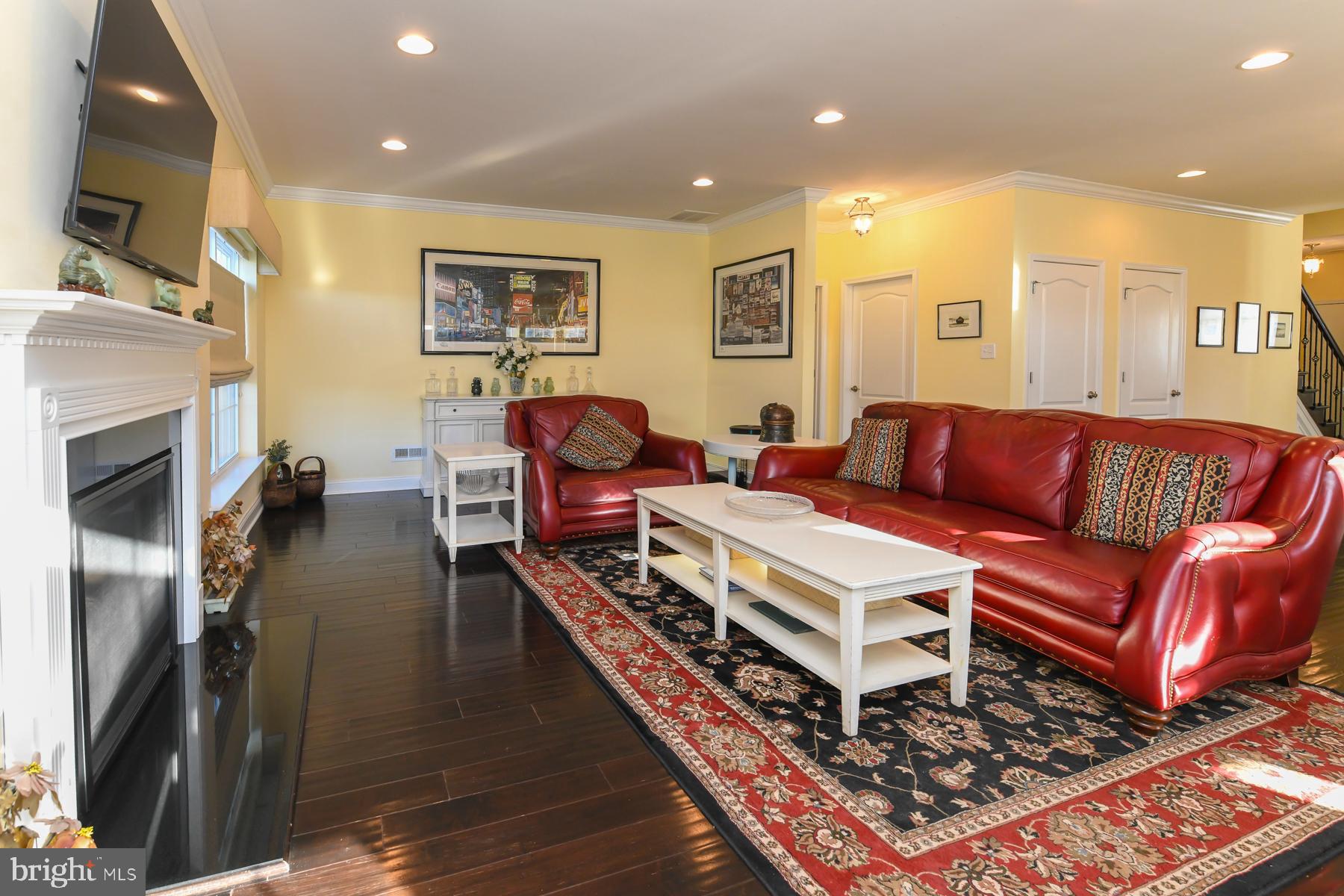 111 Weatherby Lane Glassboro, NJ 08028 - Photo 30 of 95 a living room with furniture a flat screen tv and a fireplace