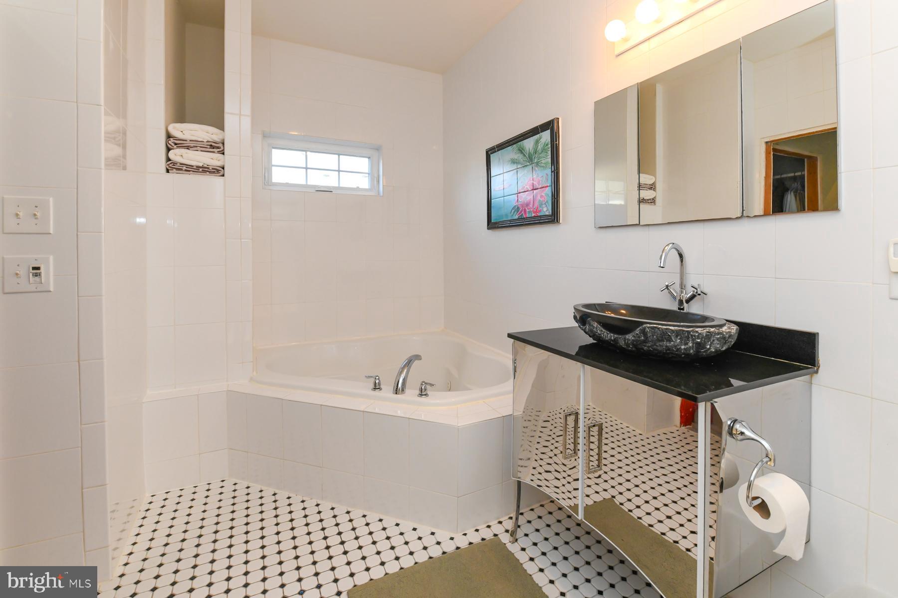 111 Weatherby Lane Glassboro, NJ 08028 - Photo 36 of 95 a bathroom with a sink a mirror and a bathtub