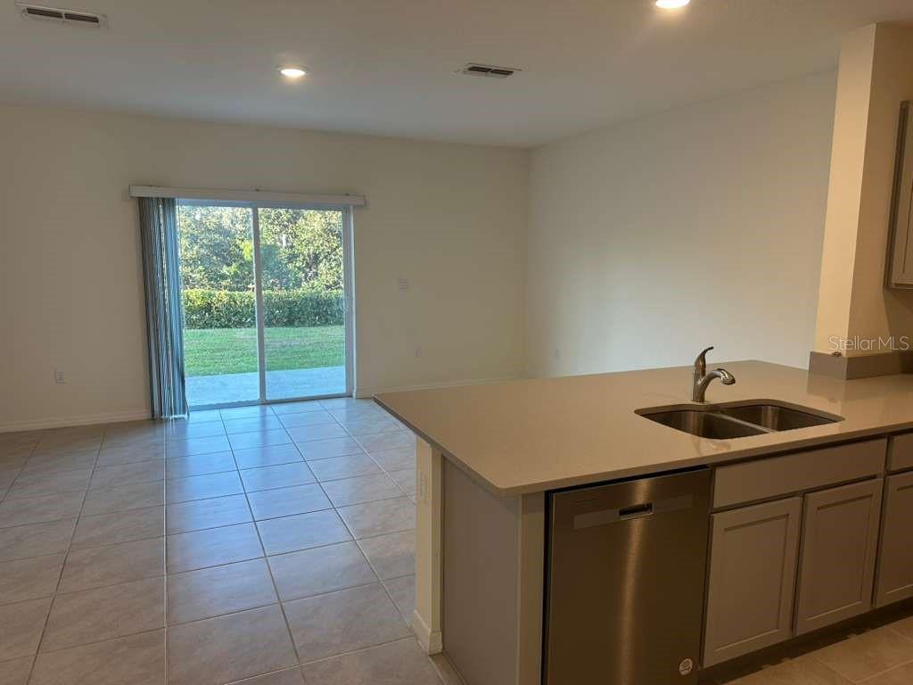 1773 Rock Elm Road Davenport, FL 33837 - Photo 19 of 23 a kitchen with a sink and cabinets