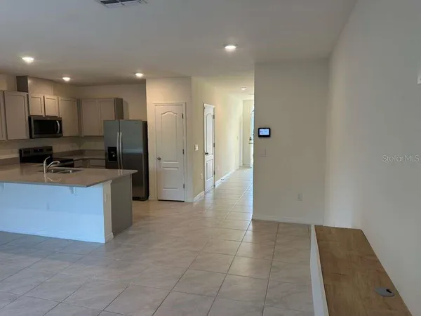 a kitchen with stainless steel appliances a refrigerator and a stove top oven