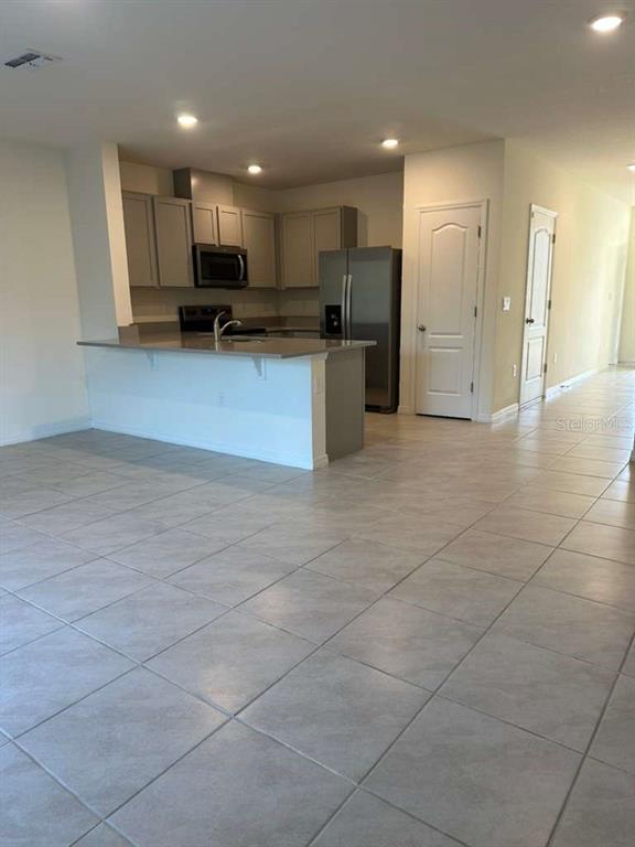 1773 Rock Elm Road Davenport, FL 33837 - Photo 22 of 23 a view of kitchen with refrigerator and window